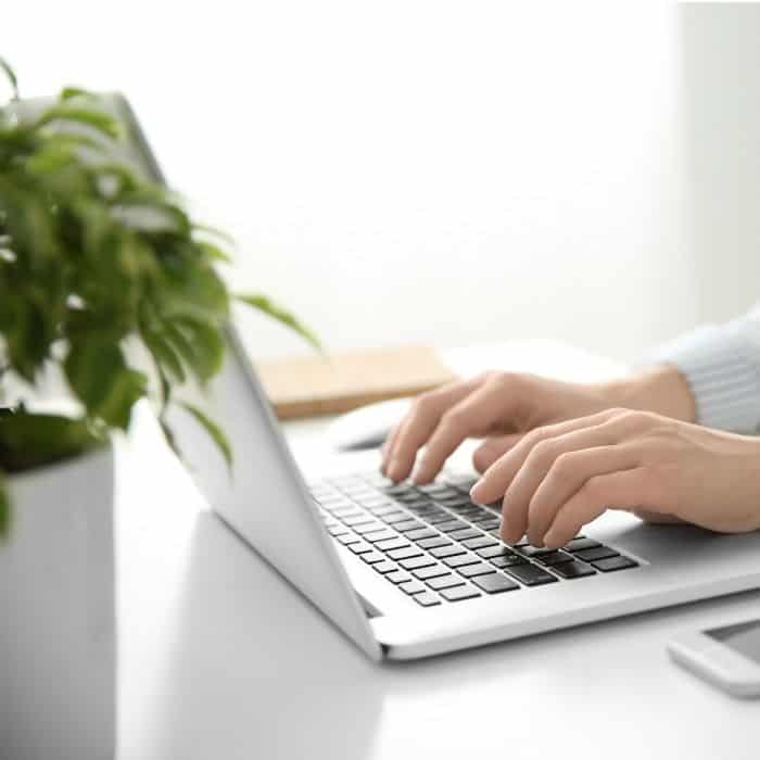 man typing on laptop